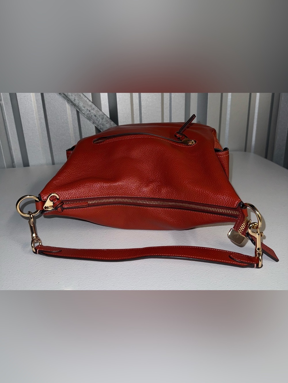 Coach Pennie Shoulder Bag features gold hardware and side suede pockets - Picture 10 of 15